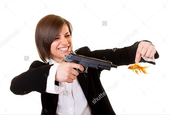 WTF stock photos woman with gun held up against a fish