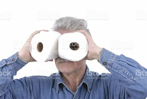 man using toilet paper as binoculars WTF stock photos