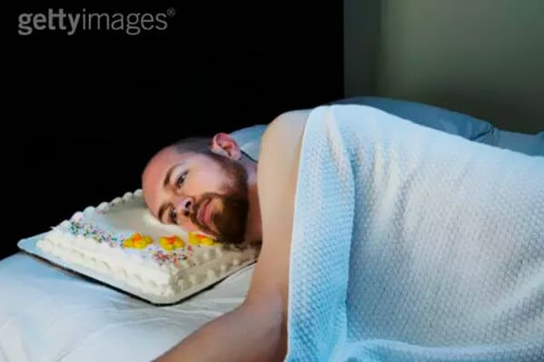 WTF stock photos man sleeps on a cake as a pillow