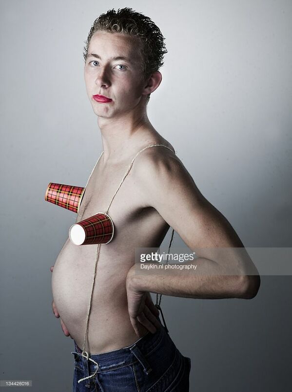WTF stock photos man with cups over his nipples pretending to be pregnant