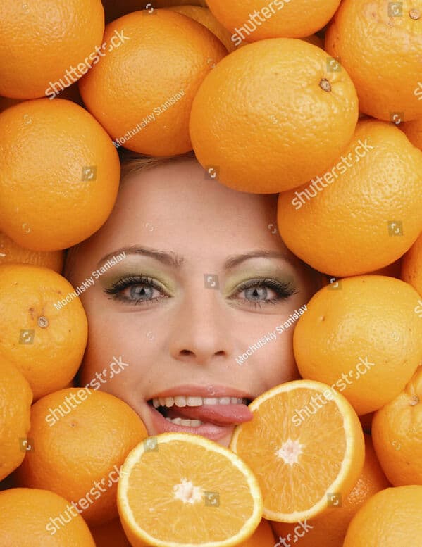 woman licking oranges WTF stock photos