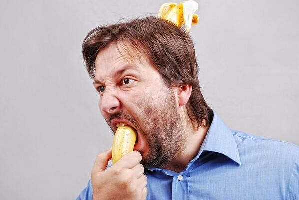 WTF stock photos banana in mouth and banana coming out of the back of his head