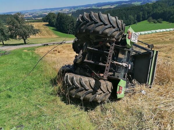 tractor on its side in a field, funny people having a worse day, well that sucks