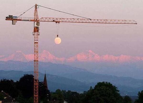 crane that looks like its carrying moon, Funny Fake history photos, r fakehistoryporn, facts about history that are not true, false textbook photos, historical pics with funny captions, lol, jokes, old photos with hilarious explanations, funny pics