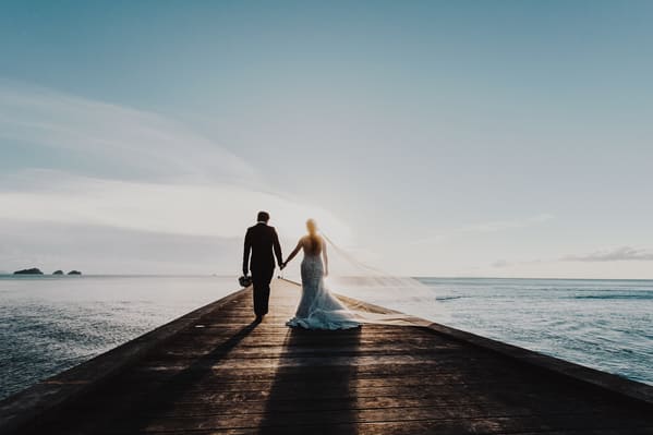married couple walking on pier, Funny wedding shower thoughts, Funny marriage thoughts, observations about getting married, wedding photos